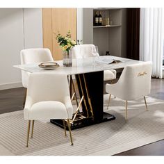 a dining room table with white chairs and a black base in front of a window