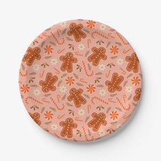 a pink plate with ginger cookies and flowers on the front, against a white background