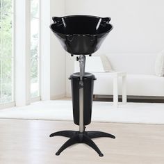 a black bowl on a stand in a living room