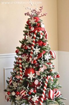 a red and white christmas tree with candy canes