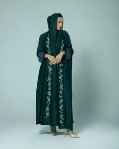 (Estimated delivery for pre-orders: 10/02/25 - 14/02/25. If you require a quicker delivery, please contact us). Giving elegant modesty, the 'Amani' abaya is perfect for all occasions. The satin fabric gracefully flows and is adorned with hand embellished intricate beading on the cuffs and collar. - Scarf and slip dress included. - Dry clean only. - Cool iron. - Colours may vary. - Model is 5'6 wearing size 54. Elegant Long Sleeve Abaya With Embroidered Border, Eid Embellished Green Abaya, Silk Maxi Abaya For Eid, Elegant Green Embroidered Abaya, Elegant Embroidered Green Abaya, Elegant Hand Embellished Long Sleeve Abaya, Elegant Long Sleeve Hand Embellished Abaya, Silk Long Abaya For Eid, Long Silk Abaya For Eid