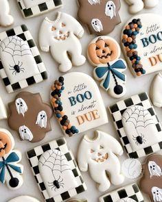 decorated cookies are arranged on a table for halloween