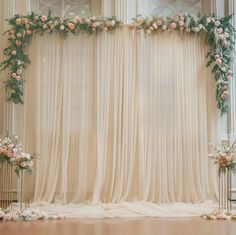 the wedding arch is decorated with flowers and greenery