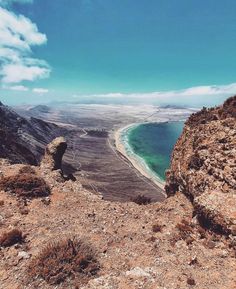 the view from top of a mountain looking down at an ocean