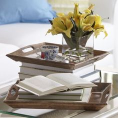 a tray with books and flowers on it