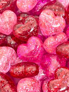 heart shaped candies are in pink and red glittery colors, as if for valentine's day or other special occasion