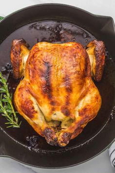 a roasted chicken in a cast iron skillet with the title buttermilk roast chicken