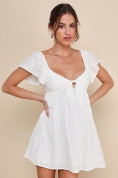 Make everyone feel like they're on cloud nine by just looking at you in the Lulus Heavenly Cutie White Embroidered Tie-Back Mini Dress! Lightweight cotton-blend fabric, with pierced eyelet embroidery throughout, shapes a V-neckline that secures with a cute tie detail atop a keyhole-style cutout. Fluttery short sleeves (with elastic at the shoulders) frame the seamed bodice and the fitted empire waist that sits atop an A-line mini skirt. Turn around to reveal an open-back design with sash ties. E Summer Cotton Mini Dress With Broderie Anglaise, Floral Embroidered Cotton Mini Dress For Brunch, Cotton Mini Dress With Floral Embroidery For Brunch, Chic Floral Embroidery Cotton Mini Dress, Chic Cotton Mini Dress With Floral Embroidery, Chic Cotton Mini Dress With Broderie Anglaise, Spring Cotton Mini Dress With Broderie Anglaise, White Wedding Guest Dresses, Knot Tie Dress