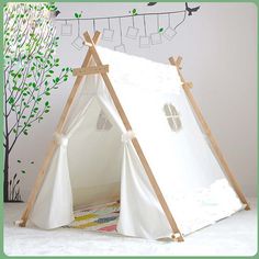 a teepee tent with clothes hanging on the clothesline