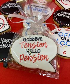 decorated cookies in the shape of speech bubbles on a red table with white and black lettering