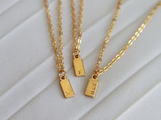 Personalize your necklace and create a meaningful gift with our Initial Tag Necklace. Ideal for everyday wear and layering, this stunning necklace is the perfect gift for yourself, loved ones, bridesmaids, or weddings. Each item is meticulously hand-stamped and personalized, offering a variety of meanings and love. Crafted with tarnish-resistant stainless steel, our materials ensure long-lasting beauty. Customize the charm with one to three characters (letters or numbers) to make it uniquely yours. The necklace hangs elegantly from a 16-inch chain with a 2-inch extender. It comes ready to be gifted on a jewelry card. Materials: - Hypoallergenic stainless steel chain  - Stamped stainless steel tag - Chain length: 16 inch + 2  inch extender Personalization:  You have the option to personaliz Simple Initial Pendant Charm Necklace For Gift, Minimalist Initial Pendant Charm Necklace For Gift, Minimalist Initial Pendant Charm Necklace As Gift, Simple Initial Necklace With Clavicle Chain As Gift, Delicate Chain Initial Necklace For Mother's Day, Delicate Initial Necklace For Mother's Day Gift, Mother's Day Gift Initial Necklace With Delicate Chain, Mother's Day Gift: Delicate Chain Initial Necklace, Simple Rectangular Necklace For Gift