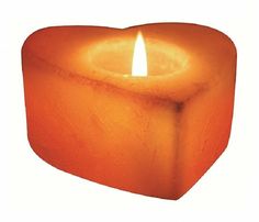 an orange candle is lit in the shape of a heart