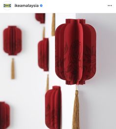 red paper lanterns hanging on the wall with tassels