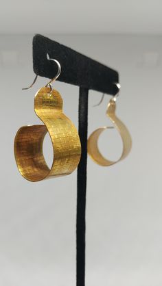 Hand-crafted texturized brass hoops, 3/4" inches in diameter. Ear hooks are .925 Sterling Silver. Small Hoop Metal Wrap Earrings, Modern Small Hoop Hammered Earrings, Gold Hammered Metal Hoop Earrings, Modern Hammered Small Hoop Earrings, Bronze Metal Hoop Jewelry, Unique Hammered Brass Jewelry, Unique Gold Hoop Jewelry, Unique Small Hoop Metal Earrings, Bronze Ear Wire Hoop Earrings In Brass