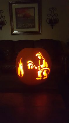 a carved pumpkin sitting on top of a couch