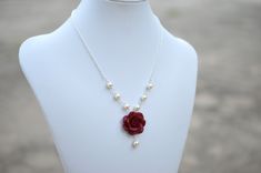 "Featuring 25mm Hand Sculpted Deep Red (Garnet) Rose and pearls Centered Necklace. Matching Red Rose Earrings: https://www.etsy.com/listing/165095225/red-rose-and-pearls-earrings-dangle-rose?ref=shop_home_active Note : Drop a note if you prefer Fired red rose or Succulent Rose, otherwise will be shipped as Garnet Red Rose. Material and size : Rose Clay Flower is approximately 25-26mm across. 6-8mm Ivory /cream/Off-white glass pearls. White pearls available. Swarovski available with additional co Red Flower-shaped Necklace With Rose Design, Red Flower Necklace With Rose Design, Red Floral Rose Design Necklace, Red Rose Design Flower Necklace, Formal Red Flower Necklace, Red Rose Design Necklace For Wedding, Red Rose Design Jewelry For Wedding, Red Rose Design Wedding Jewelry, Red Rose Jewelry