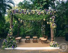 an outdoor wedding setup with flowers and greenery