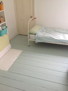 a bedroom with blue floors and white walls