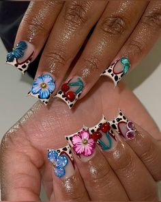 two woman's hands with colorful nail designs on them