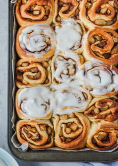 cinnamon rolls with icing in a baking pan