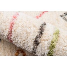 a close up view of a white and black rug with multicolored stripes on it