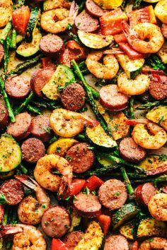 a sheet pan filled with sausage, shrimp and asparagus