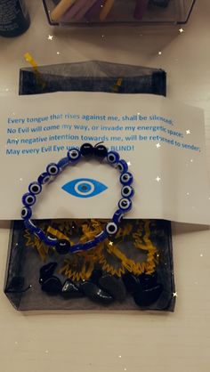 an evil eye bracelet is displayed on a table