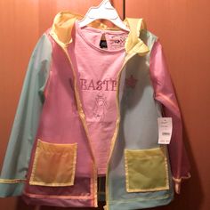 This Is A New Set Of A Plastic Raincoat And A Pink Embroidered T-Shirt With Cute Bunnies T-Shirt Has Ruffles In The Front And Plain Back Side Match It Up With Some Easter Leggings Or A Pair Of Skinny Blue Jeans Jacket Is 100pct Polyurethane, Machine Wash Warm And Tumble Dry Low Shirt Is 61 Pct Cotton And 39 Pct Polyester, Machine Wash Warm And Tumble Dry Low Multicolor Fall Outerwear For Playtime, Fun Multicolor Long Sleeve Outerwear, Casual Long Sleeve Outerwear For Play, Hooded Raincoat For Spring Playtime, Spring Playwear Cotton Outerwear, Fun Multicolor Cotton Outerwear, Spring Cotton Outerwear For Play, Casual Multicolor Hooded Raincoat, Fun Pink Spring Outerwear