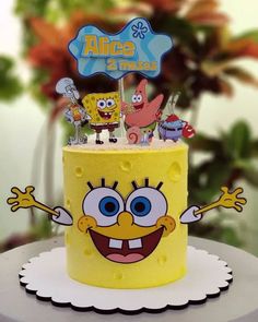 a yellow spongebob cake with cartoon characters on top