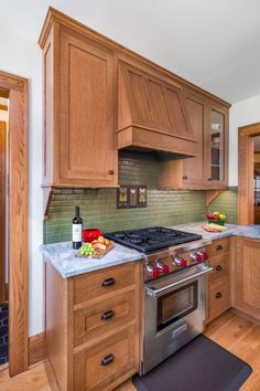 a kitchen with wooden cabinets and stainless steel appliances