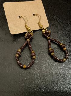 A pair of earrings made with chocolate brown beads of two different sizes ( 6/o and 11/o) and cognac beads (8/o) approximately 2 inches long with hook backs Aloe Vera Gel, Chocolate Brown, Beaded Earrings, Cognac, Wrap Bracelet, Jewelry Earrings Dangle, Etsy Earrings, Dangle Drop Earrings, Dangle Earrings