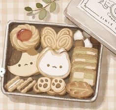 an open tin with some cookies and other food items in it on a checkered table cloth