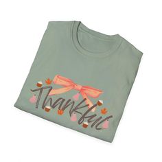 This girly coquette Thanksgiving Fall T-Shirt exudes a warm and festive vibe, perfect for celebrating the autumn season. It is relevant to those who enjoy expressing their love for fall holidays and festivities. Product features - Made from 100% ring-spun cotton for a lightweight and comfortable feel - Classic fit with crew neckline for versatile styling - Ethically grown and harvested US cotton for sustainability - Features ribbed knit collar and shoulder tape for durability - Perfect for printing with specially spun fibers for smooth fabric Care instructions - Do not dryclean - Machine wash: warm (max 40C or 105F) - Do not bleach - Tumble dry: low heat - Iron, steam or dry: low heat Green Tops For Fall Holiday, Cute Cotton Winter T-shirt, Cute Cotton T-shirt For Winter, Fall Season T-shirt Gift, Fall Gift T-shirt With Short Sleeves, Letter Print T-shirt As Fall Gift, Short Sleeve T-shirt For Fall Gift, Cotton T-shirt For Fall Holiday, Fall Short Sleeve Tops For Gift