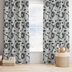 the curtains are decorated with green and white tools on them, along with a teddy bear