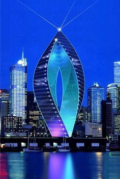 the city skyline is lit up in blue and purple with an unusual shaped leaf on it