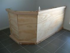 a wooden counter sitting on top of a tiled floor