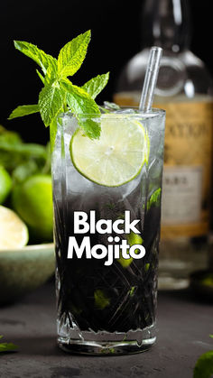 a black mojito with limes and mint on the side