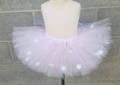 a mannequin wearing a pink and white tutu with snowflakes on it