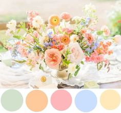 a vase filled with flowers sitting on top of a table next to a color palette