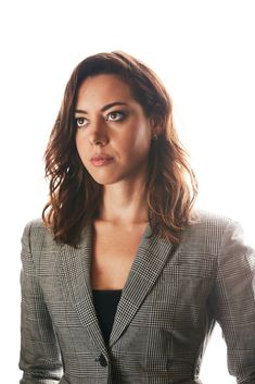 a woman in a suit posing for the camera