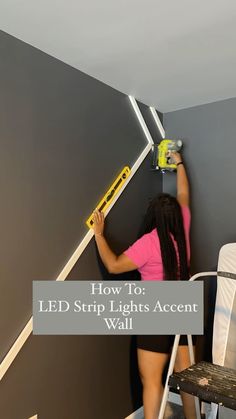 a woman is painting the walls in her bedroom