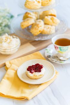 there is a plate with some cookies on it and a cup of tea next to it