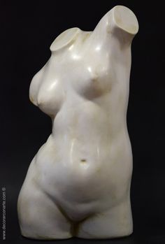 a white sculpture sitting on top of a black surface