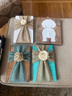 four pieces of wood with bows on them