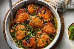 a white bowl filled with chicken and greens