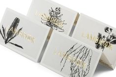 three cards with different types of plants and words in gold foil on them, sitting next to each other