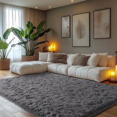 a living room with a large gray rug on the floor next to a white couch