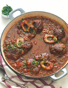 a pot filled with meat and vegetables on top of a table