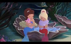 two little mermaids are sitting in an ocean shell