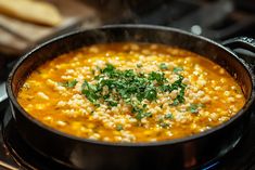 a pot filled with soup sitting on top of a stove